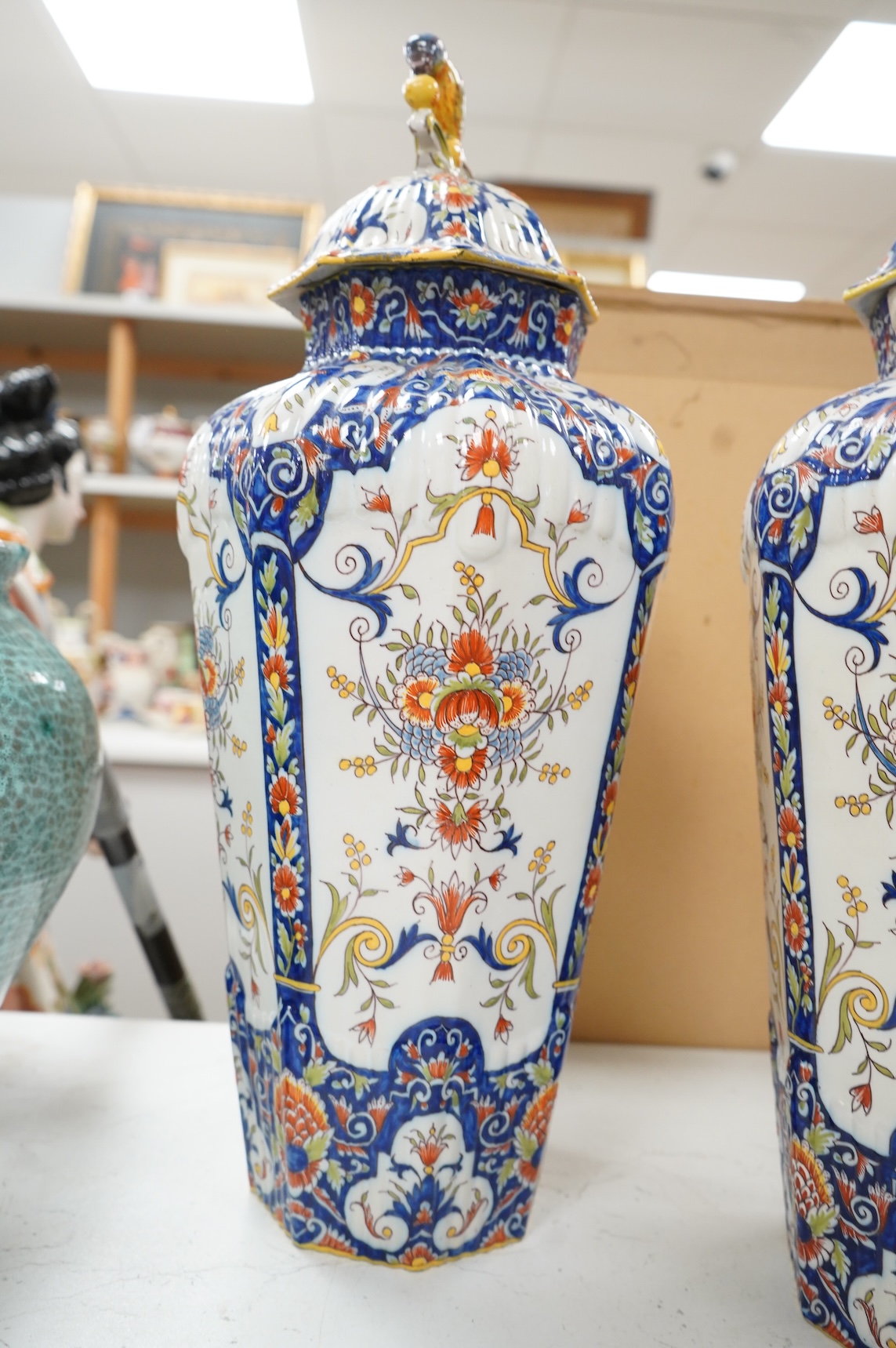 A pair of early 20th century Rouen faience vases and covers, the knops in the form of birds, 49cm high